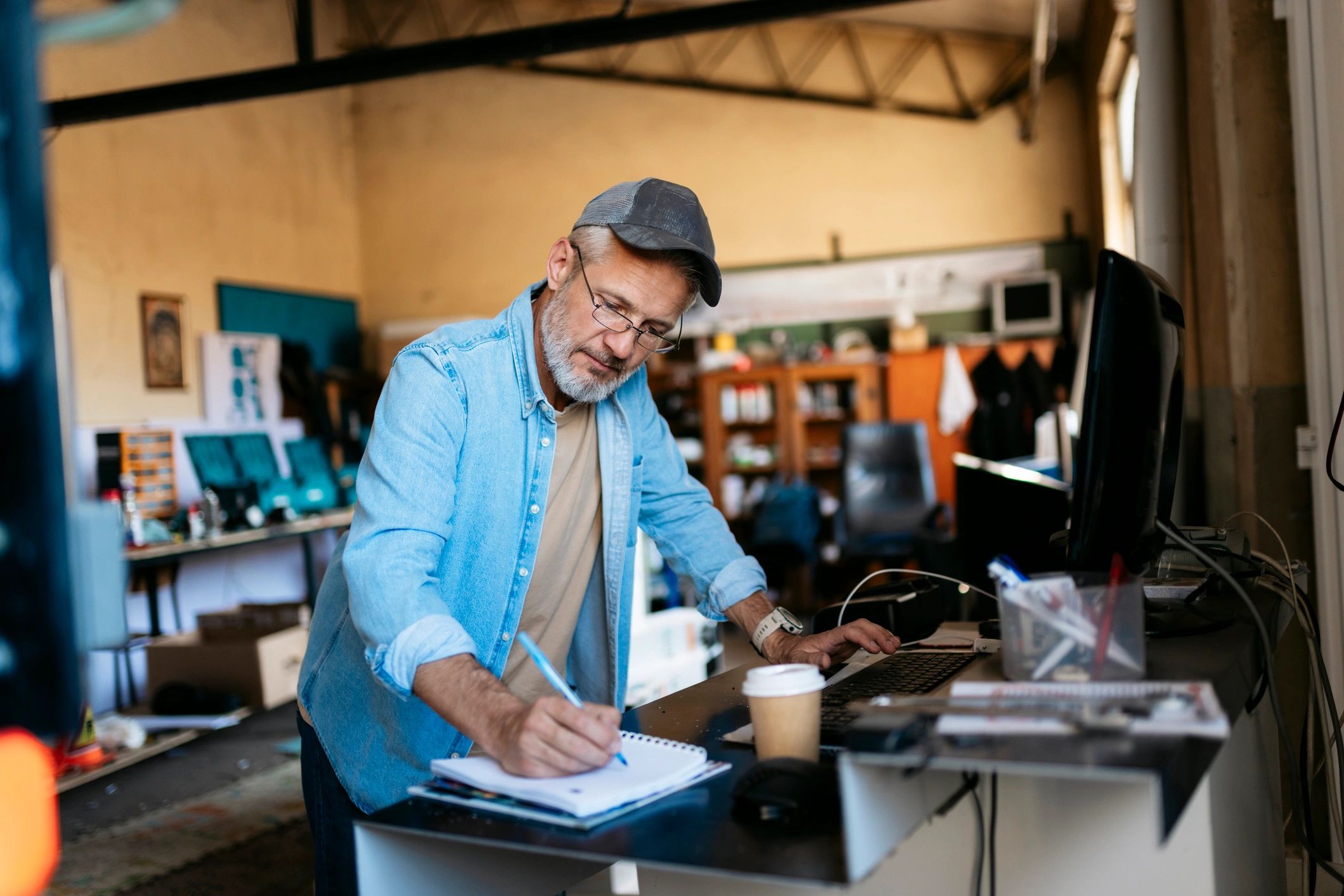 Small business owner planning and taking notes at a computer