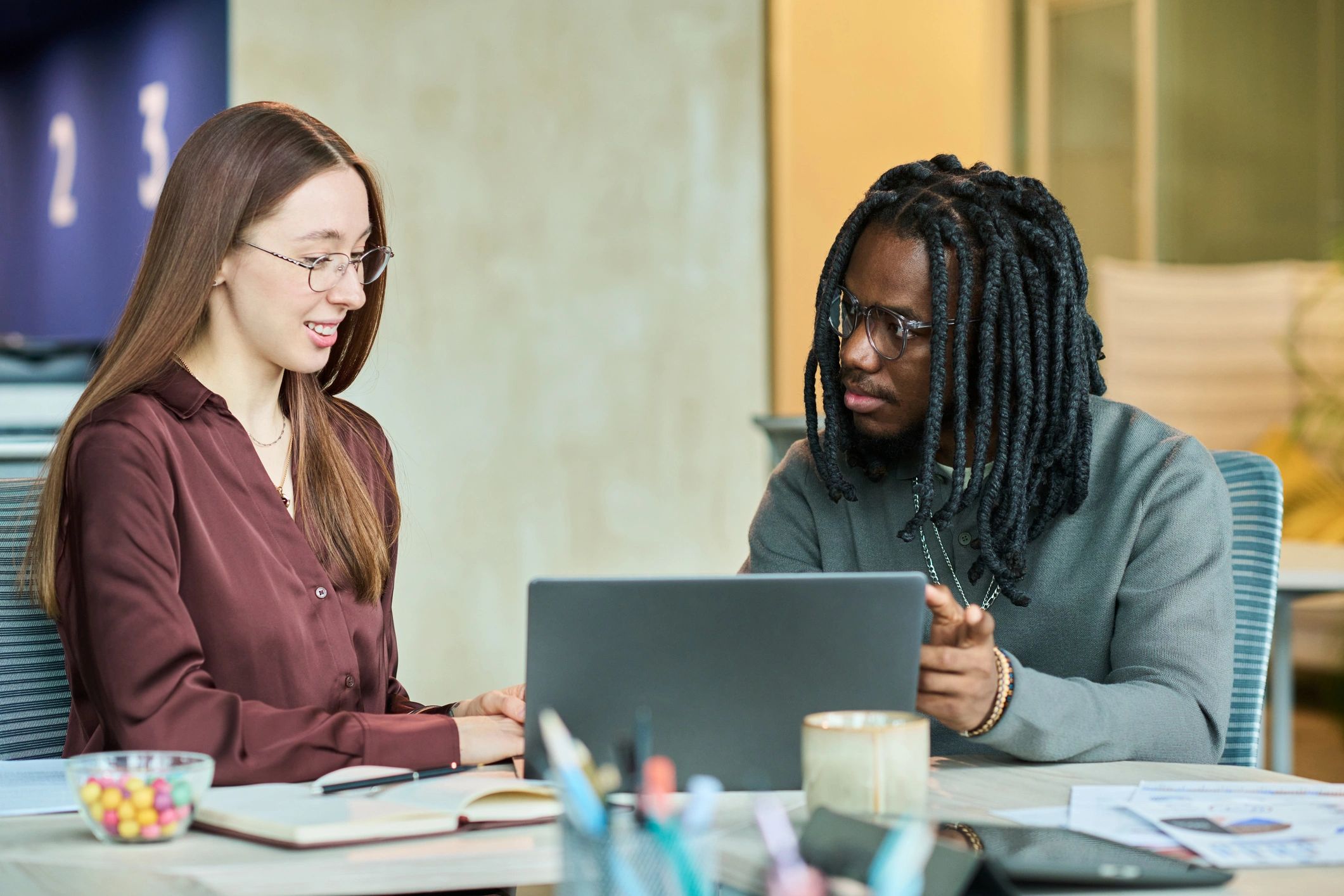 Business colleagues collaborating on a laptop